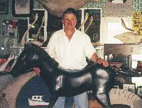 Jay Cherrix stands in his decoy shop in front of a pony he carved for fun. His unique carvings include shorebirds and fish, and range from primitive working decoys to refined pieces that resemble modern sculpture.